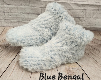 May include: A pair of light blue fluffy slipper socks. The socks are made of a soft, fluffy material and have a comfortable fit.