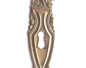 Antique Brass Escutcheon with bird, keyhole cover, frame.