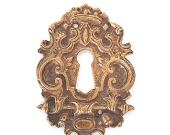 Antique brass escutcheon, keyhole cover, empire.