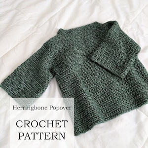 May include: A green crochet popover sweater with a herringbone stitch pattern. The text "Herringbone Popover CROCHET PATTERN By Lady Jay Crochet" is printed below the sweater.