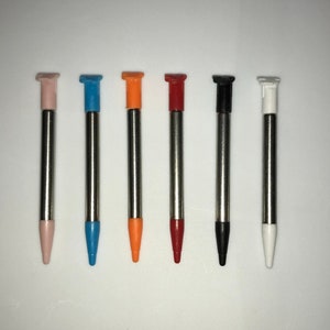 May include: Six stylus pens with different colored tips. The tips are pink, blue, orange, red, black, and white.