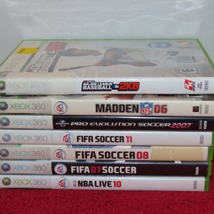 May include: A stack of eight Xbox 360 video game cases. The games include Major League Baseball 2K8, Madden NFL 06, Pro Evolution Soccer 2007, FIFA Soccer 11, FIFA Soccer 08, FIFA 07 Soccer, and NBA Live 10.