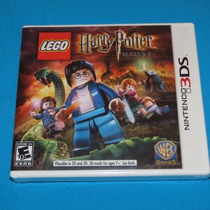 May include: A white Nintendo 3DS game case with a colorful image of Lego Harry Potter Years 5-7. The image features a Lego Harry Potter minifigure holding a wand, a green snake, and other Lego characters.