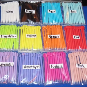 May include: Assortment of 10 different colored stylus pens in individual clear plastic bags. The colors are white, black, aqua, teal, lime green, yellow, orange, red, lavender, amethyst, fuchsia, and pink. Each bag has a label with the color name.
