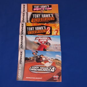 May include: A stack of five instruction booklets for Tony Hawk's skateboarding video games for the Game Boy Advance. The titles include Tony Hawk's American Sk8land, Tony Hawk's Underground, Tony Hawk's Underground 2, Tony Hawk's Downhill Jam, and Tony Hawk's Pro Skater 4.