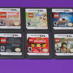 May include: Six Nintendo DS game cartridges featuring Lego characters and themes. The games include Lego Marvel Super Heroes, Lego Friends, Lego Harry Potter, Lego Pirates of the Caribbean, Lego Battles Ninjago, and Lego Lord of the Rings.