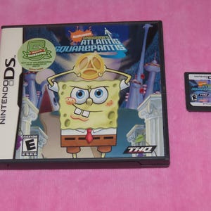 May include: A Nintendo DS game case and cartridge for "SpongeBob's Atlantis SquarePantis." The case features SpongeBob SquarePants with a golden crown. The game is rated "E" for Everyone.