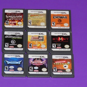 May include: Nine Nintendo DS game cartridges, including Shogun Empires, Indiana Jones and the Staff of Kings, Endwar, Splinter Cell Chaos Theory, Dynasty Warriors DS, The Mummy Tomb of the Dragon Emperor, Spectrobes, Spectrobes, and Operation: Vietnam.