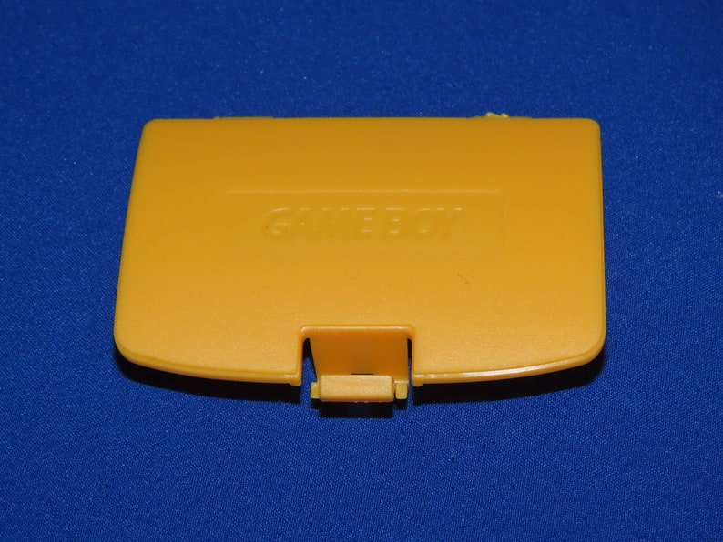 May include: A yellow Game Boy Color game cartridge case with the word "GAME BOY" printed on the front.