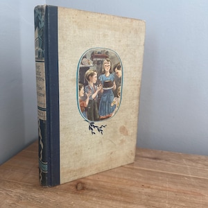 May include: A vintage children's book titled "Five Little Peppers and How They Grew" with a blue spine and a colorful illustration of five children on the cover.
