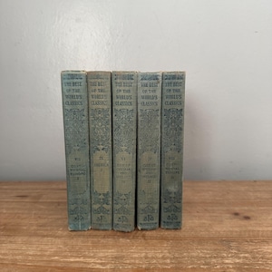 May include: A collection of five antique books titled "The Best of the World's Classics." The books have a teal cover with ornate gold lettering and designs. The spines display the volume numbers and geographical regions.