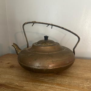 Vintage copper kettle with covered woven handle