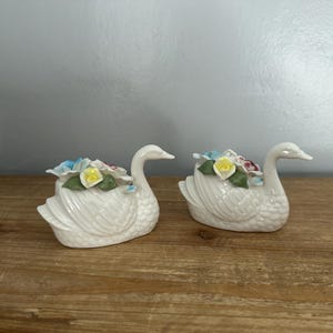 Set of 2 vintage porcelain swans with 3D flowers on back