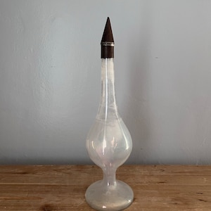 Vintage glass decanter with tin topper