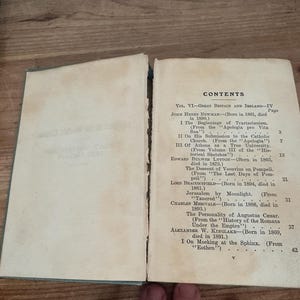 May include: Open book with the contents page visible. The page is aged with visible wear and tear. The text includes the title "CONTENTS" and various chapter titles and authors, such as John Henry Newman and Edward Bulwer Lytton.