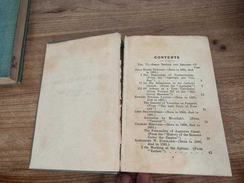 May include: Open book with the contents page visible. The page is aged with visible wear and tear. The text includes the title "CONTENTS" and various chapter titles and authors, such as John Henry Newman and Edward Bulwer Lytton.