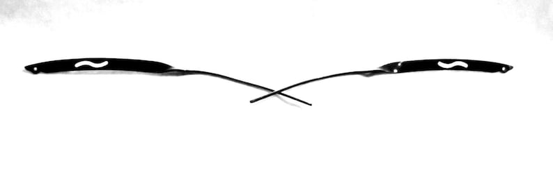 May include: Two black metal eyeglass frames with a white mustache design on each arm.