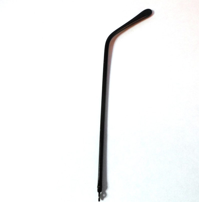 May include: A black plastic replacement temple arm for eyeglasses.