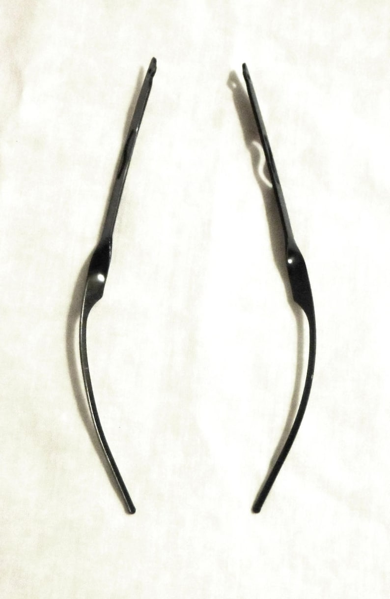 May include: Two black metal wire frames for glasses.