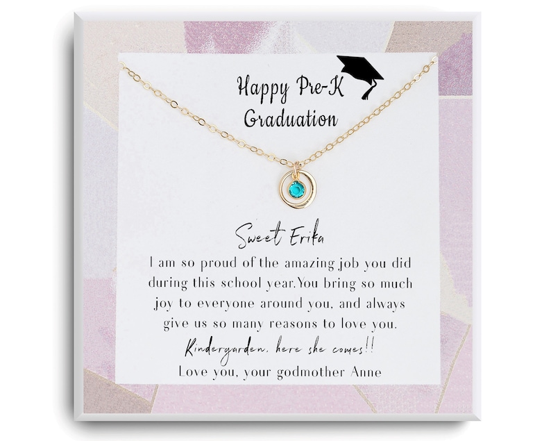 May include: A gold necklace with a turquoise gemstone pendant and a card that reads "Happy Pre-K Graduation Sweet Erika I am so proud of the amazing job you did during this school year. You bring so much joy to everyone around you, and always give us so many reasons to love you. Kindergarten, here she comes!!! Love you, your godmother Anne"