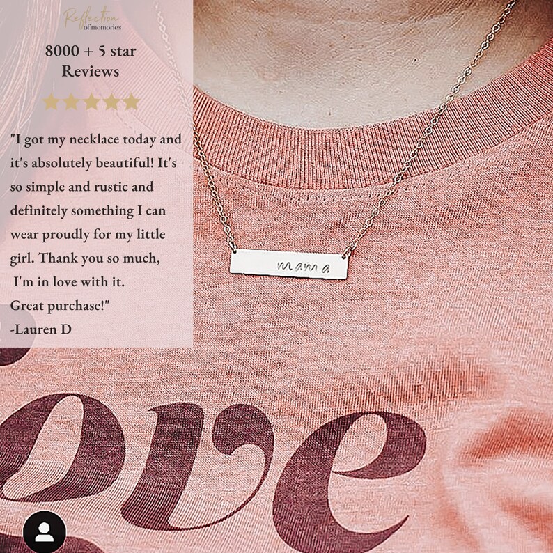 May include: A silver necklace with a bar pendant that says "mama" on a pink shirt. The necklace is on a person's chest. The shirt has the word "love" printed on it in a large font.