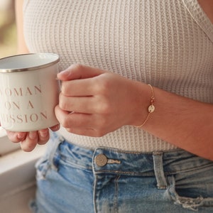 May include: White enamel mug with a pink inscription that reads "Woman on a Mission".