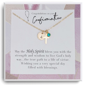 May include: Gold-colored necklace with a cross, a round charm with the letter "A", and a teal-colored gemstone. The necklace is displayed on a white card with text that reads "Congratulations on your Confirmation". The card has a pink and white background.