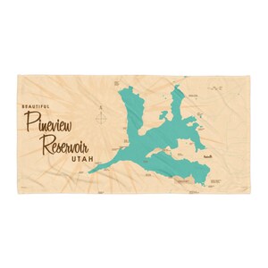 May include: A rectangular beach towel featuring a map of Pineview Reservoir in Utah. The reservoir is teal, set against a tan background with a vintage aesthetic. The words "BEAUTIFUL Pineview Reservoir UTAH" are printed in a stylized font.