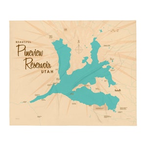 May include: A throw blanket featuring a map of Pineview Reservoir in Utah. The map is in shades of teal and tan, with the words "Beautiful Pineview Reservoir Utah" in a vintage font. The design includes a compass rose and radiating lines.
