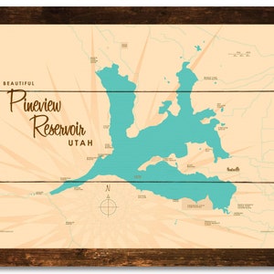 May include: A framed map print of Pineview Reservoir in Utah, featuring a teal-colored lake against a beige background. The words "Beautiful Pineview Reservoir Utah" are displayed in a vintage font. The frame is dark brown.