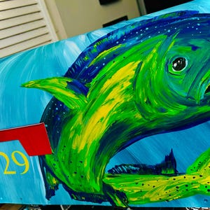 May include: A hand-painted mailbox featuring a vibrant green and yellow fish against a blue background. The fish has a detailed design with visible brushstrokes. The mailbox also includes a red flag and the number 4729 in yellow.
