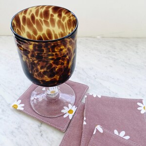 Pink daisies fabric drink coasters. Set of four 70s style coffee cup mats. Cute bar cart accessory.