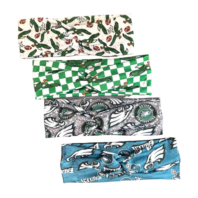 May include: Set of four green, white, and blue patterned headbands with the Philadelphia Eagles logo. The headbands are made of a soft, stretchy fabric and are perfect for showing your team spirit.