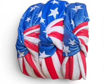 May include: Three knotted headbands with a patriotic American flag design. The headbands feature a blue background with white stars and red and white stripes, perfect for Independence Day or other patriotic events.