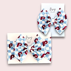 POWDER BLUE CHECK PRINT WITH 5 INCH BOW ON ALLIGATOR CLIP AND 5 INCH BOW ON INFANT HEAD WRAP. Kasey Makes Bows, Headbands and more!  Follow me @KASEY_MAKES