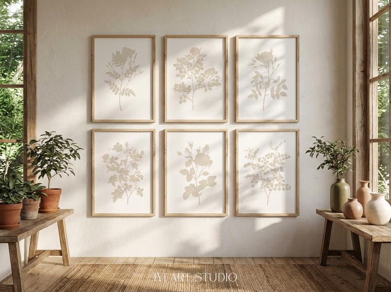 May include: A set of six rectangular wall art prints in light wood frames, each featuring a beige botanical illustration of flowers and leaves on a white background. The prints are arranged in two rows of three, with the text IVY ART STUDIO at the bottom.