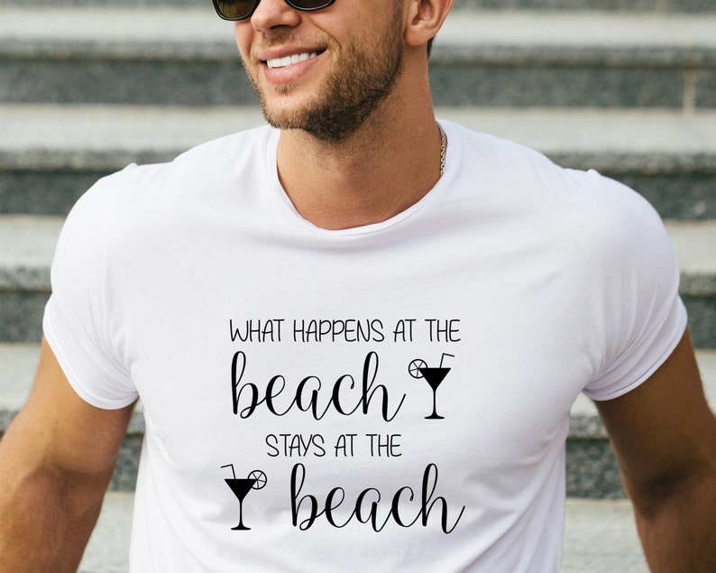 May include: White t-shirt with black text that reads "What happens at the beach stays at the beach" with a cocktail glass graphic.