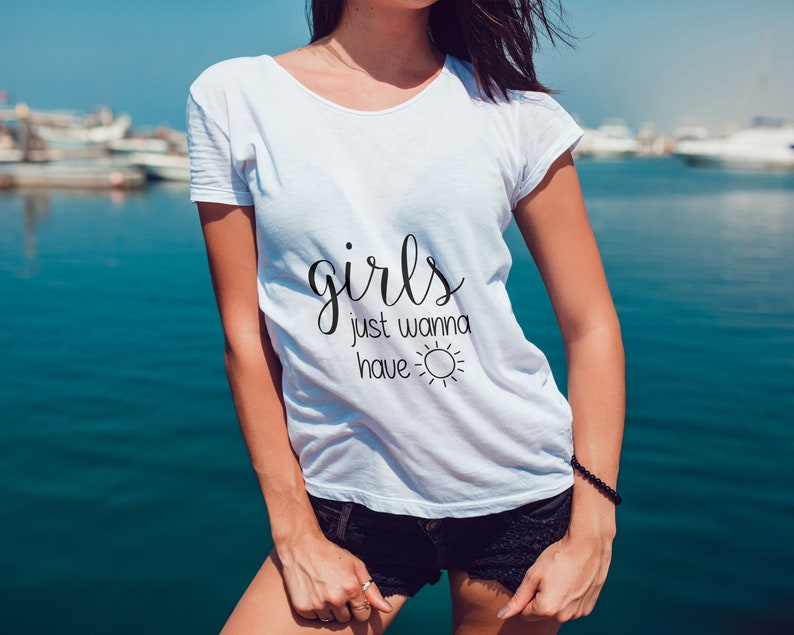 May include: White t-shirt with the text "girls just wanna have ☀️" printed on the front.