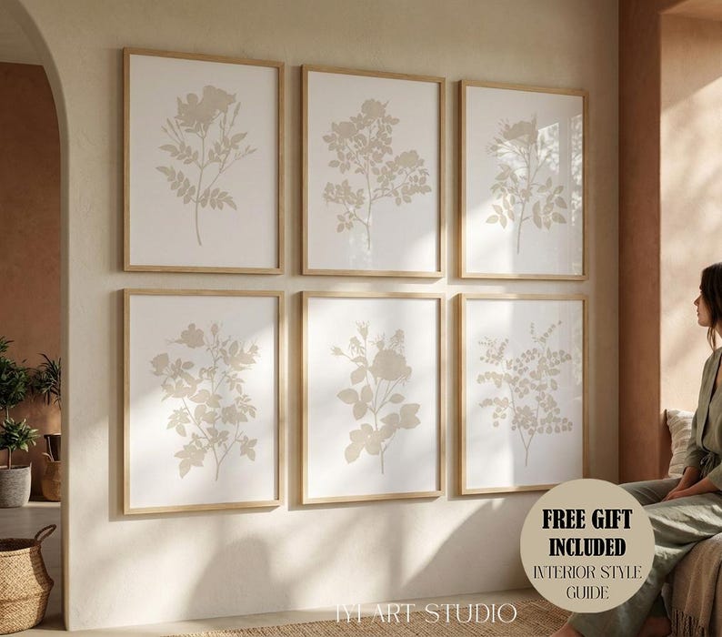 May include: A set of six framed wall art prints featuring beige botanical illustrations of various flowers and leaves on a white background, arranged in two rows of three, with light wood frames and a circular sticker reading FREE GIFT INCLUDED.