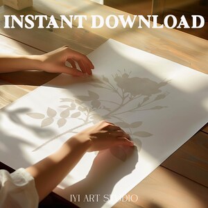 May include: A white rectangular paper print featuring a light gray botanical illustration of a rose with leaves and thorns. The text INSTANT DOWNLOAD is printed in white at the top, and the text IYI ART STUDIO is printed in white at the bottom.
