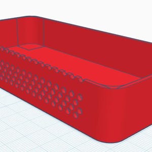 May include: A rectangular red storage tray with rounded corners and a perforated side panel featuring a grid of small circular holes. The tray has a flat base and solid walls, with a distinct notch cut into the top edge of the side wall.