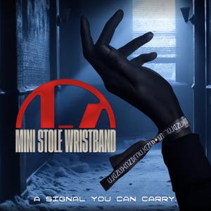 May include: A black wristband with white text is worn on a dark hand. The wristband is labelled "MINI STOLE WRISTBAND" in white text, with the tagline "A SIGNAL YOU CAN CARRY." The background is a dark, industrial setting with a red logo.