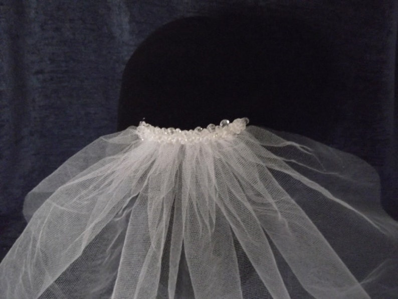 Single Tier Shoulder Length Crystal Cut Edge Bridal Veil Available in white or ivory.