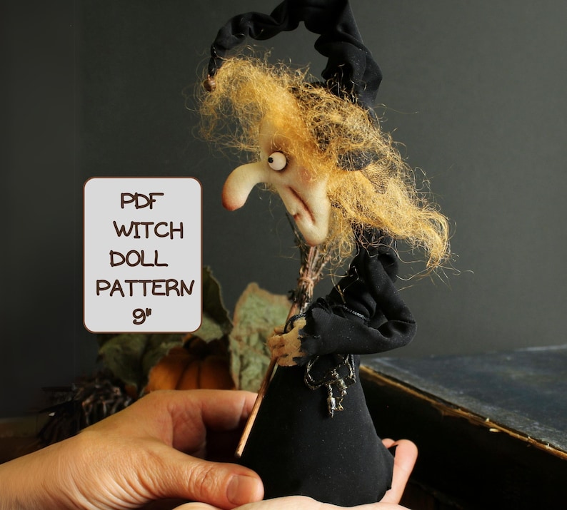 May include: A PDF pattern for a 9-inch witch doll. The doll is wearing a black dress and a pointed hat. She has long, blonde hair and a mischievous expression.