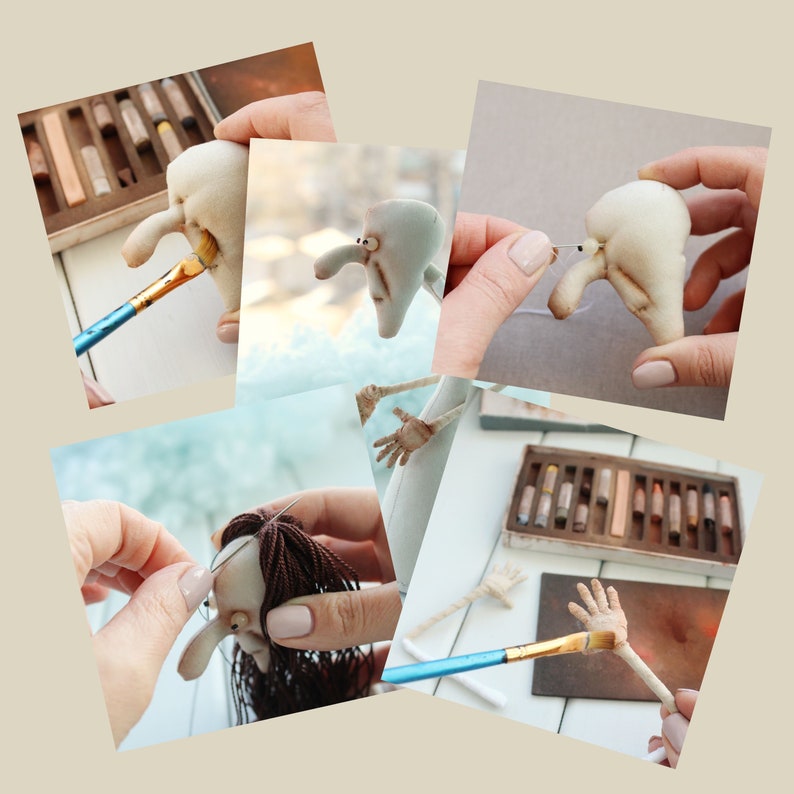 May include: A close-up of a handmade doll being assembled. The doll has a white fabric body, brown hair, and a painted face. The doll is being sewn together with a needle and thread. The doll's limbs are being painted with a brush and pastel crayons.