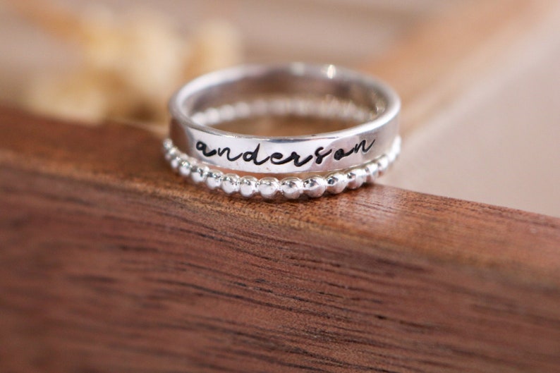 silver name ring in script font with beaded spacer ring