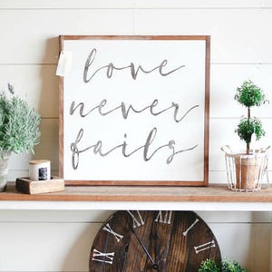 Love Never Fails Framed Wood Sign