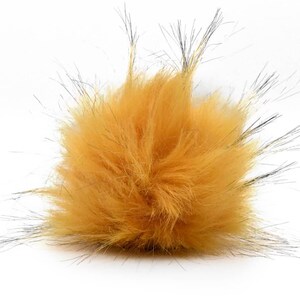 May include: A fluffy, mustard yellow pom pom with black tips. The pom pom is made of faux fur and is perfect for adding a touch of whimsy to any project.