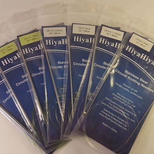 May include: A set of HiyaHiya stainless steel circular knitting needles in various sizes, packaged in clear plastic bags. The needles are smooth and flexible, perfect for knitting projects.