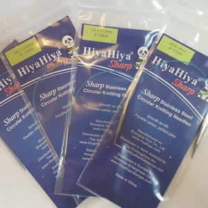 May include: Four packs of HiyaHiya Sharp stainless steel circular knitting needles in various sizes. The packs are blue with a panda bear logo and the text "HiyaHiya Sharp" printed on them.